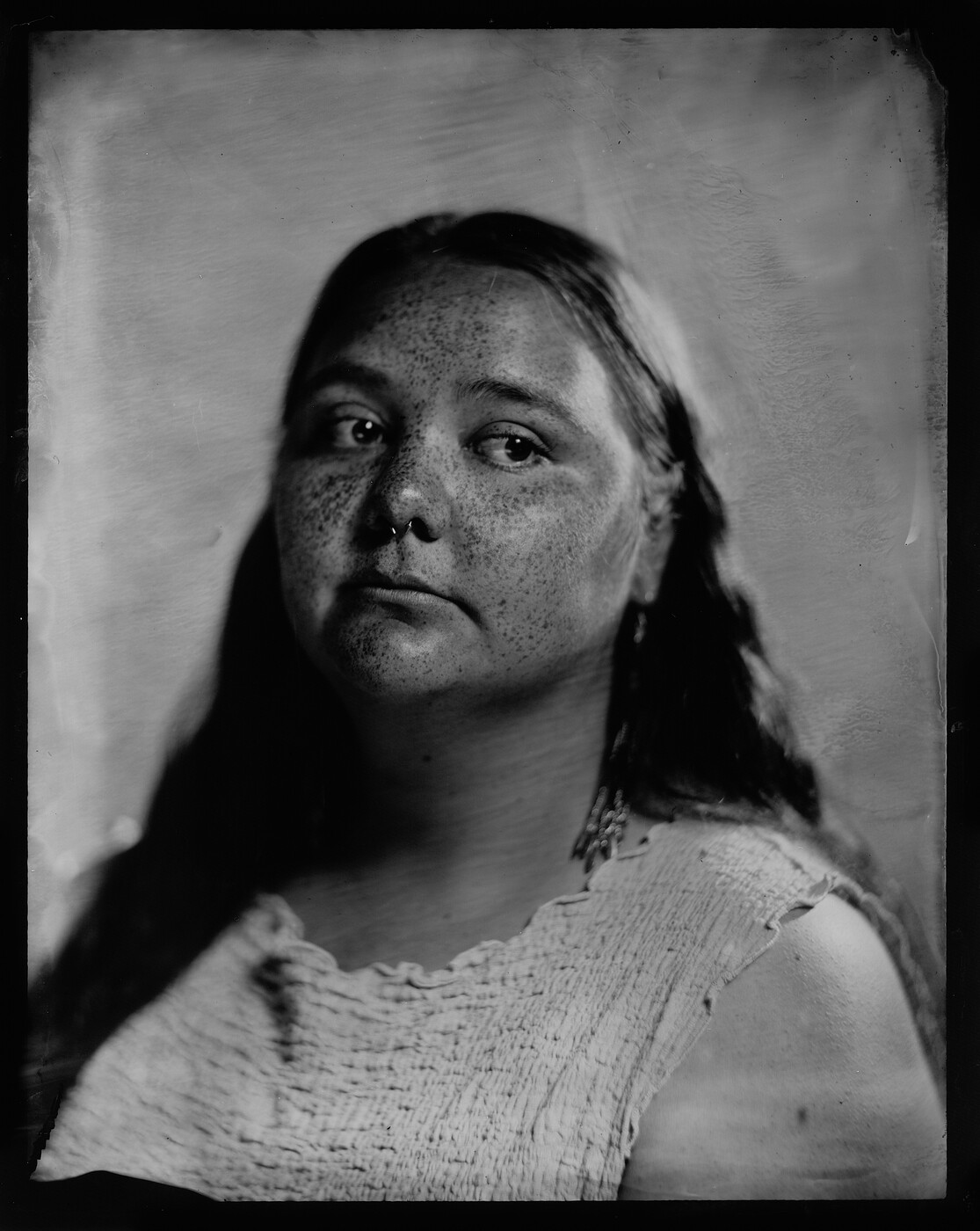 Tintype portrait of Erica Jacque — a monochrome photograph with soft antique texture, looking directly at the camera